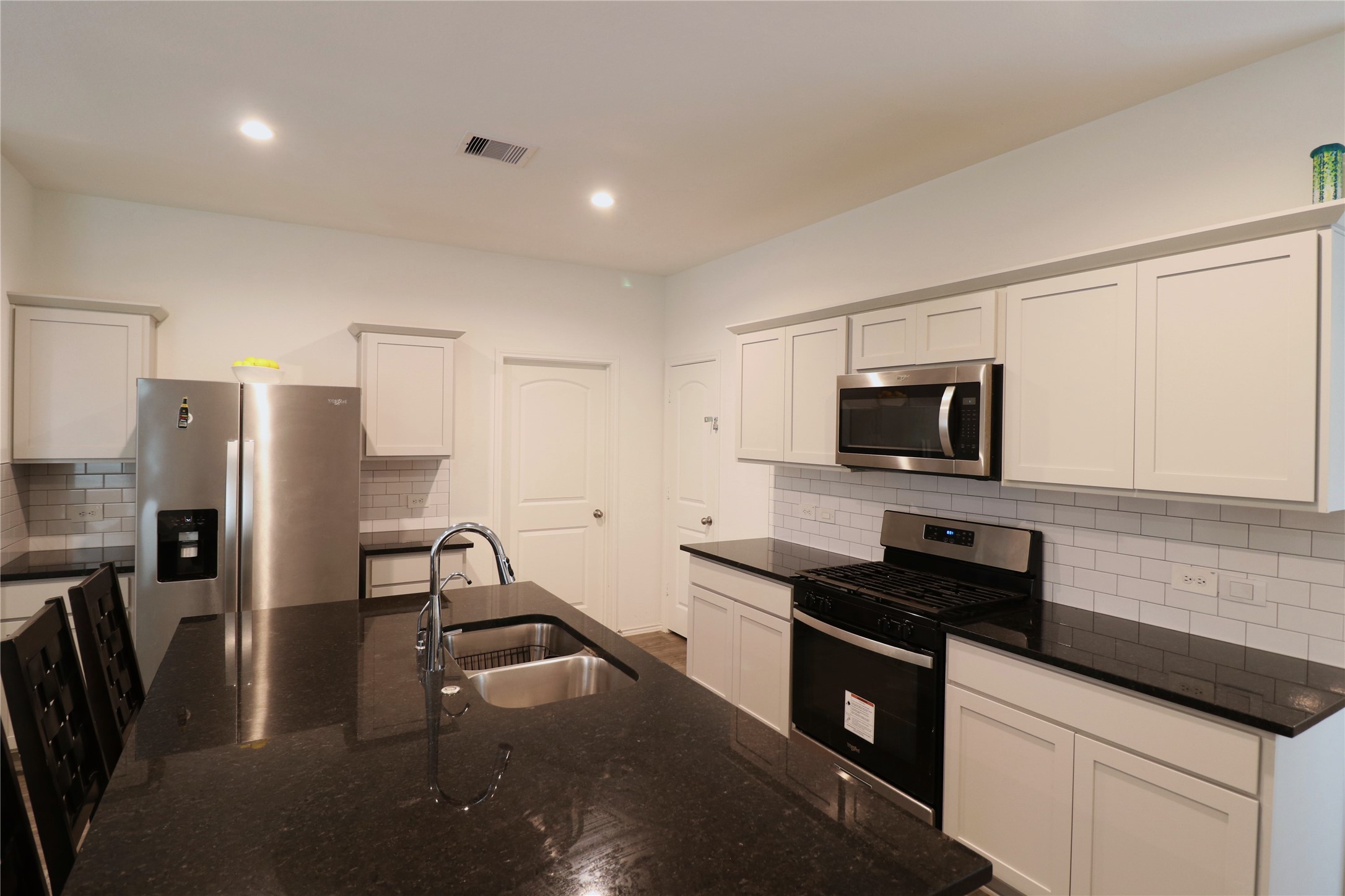 5415 Tuscany Hills Lane Spring, TX 77373 - Photo 4 of 18 a kitchen with stainless steel appliances a refrigerator a stove a microwave a sink and white cabinets