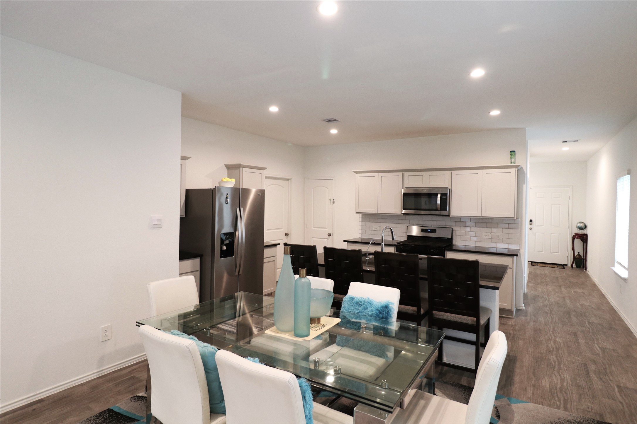 5415 Tuscany Hills Lane Spring, TX 77373 - Photo 9 of 18 a kitchen with stainless steel appliances kitchen island granite countertop a refrigerator a stove a sink a dining table and chairs