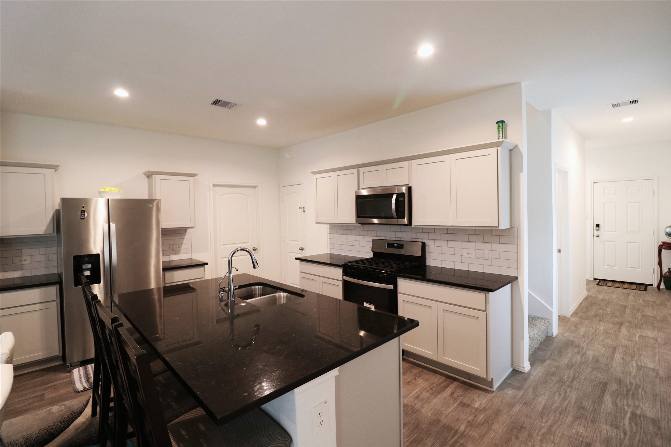 5415 Tuscany Hills Lane Spring, TX 77373 - Photo 10 of 18 a kitchen with stainless steel appliances granite countertop a sink a stove a refrigerator with a dining table and chairs