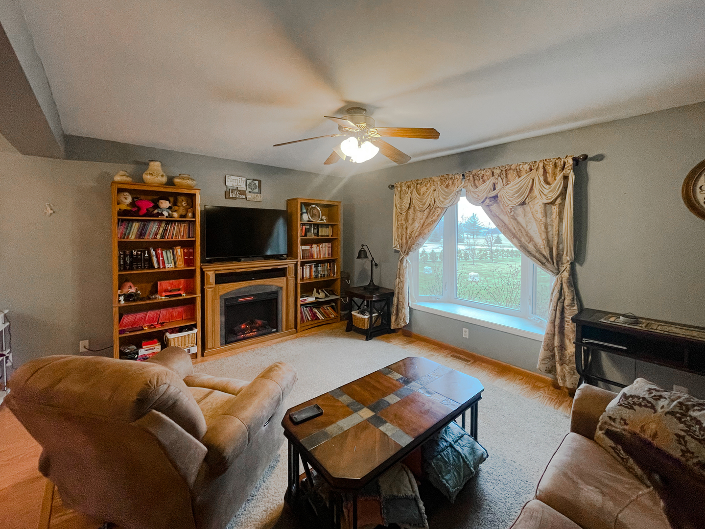 2816 2559th Road Marseilles, IL 61341 - Photo 10 of 22 a living room with furniture a flat screen tv and a large window