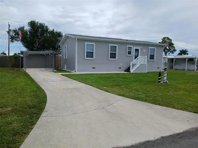 a front view of house with a garden and patio