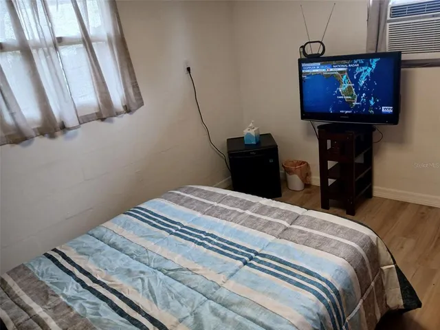 a bedroom with a bed and wall painting