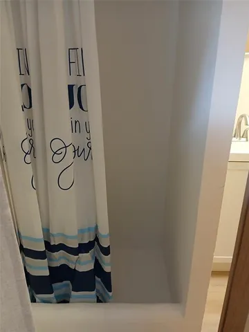 a bathroom with a bathtub and shower