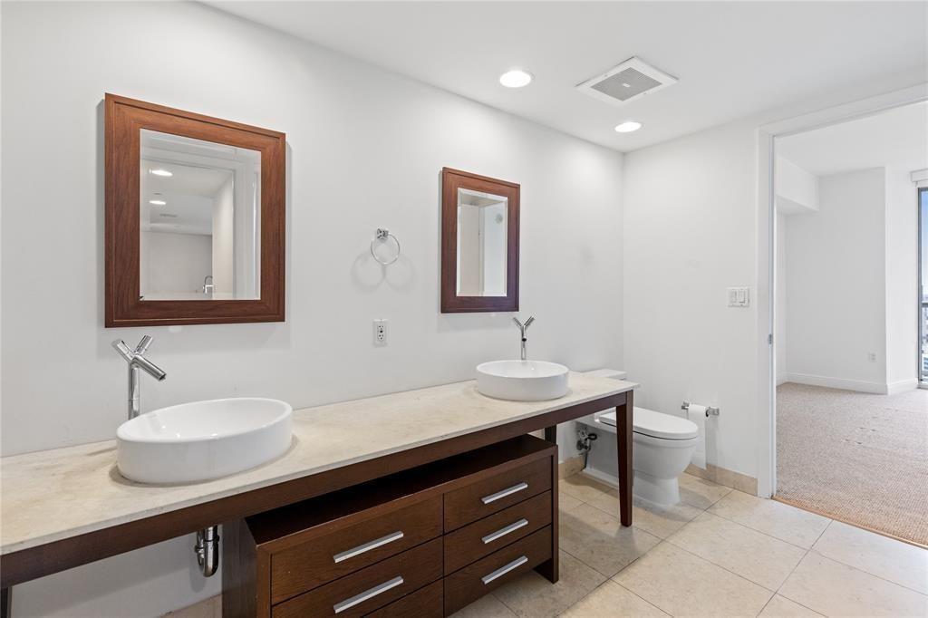 465 Brickell Avenue, Unit 2706 Miami, FL 33131 - Photo 13 of 26 a bathroom with a sink and a mirror with toilet