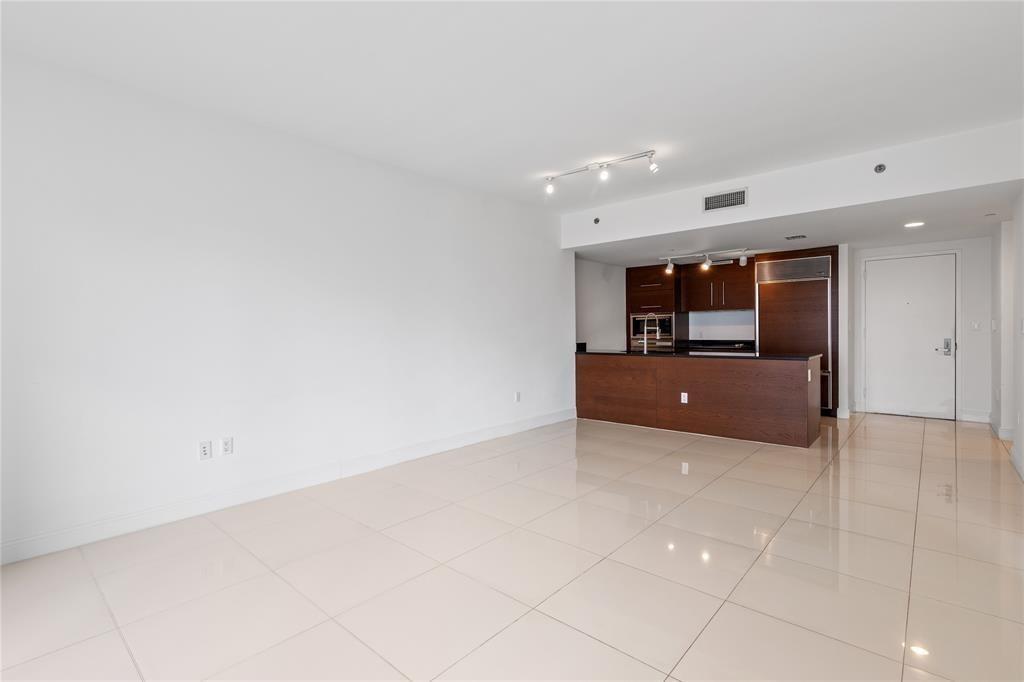 465 Brickell Avenue, Unit 2706 Miami, FL 33131 - Photo 19 of 26 a living room with couches and kitchen
