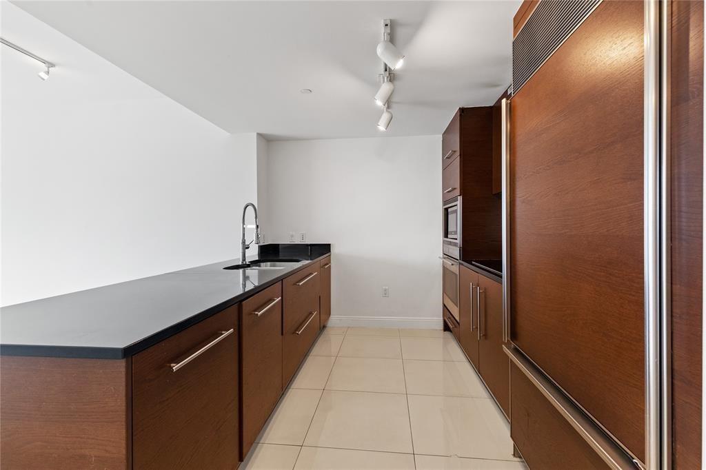 465 Brickell Avenue, Unit 2706 Miami, FL 33131 - Photo 21 of 26 a kitchen with stainless steel appliances granite countertop a refrigerator and a sink
