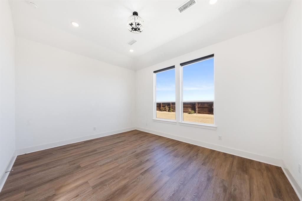 1723 Cypress Gap Trail Mansfield, TX 76063 - Photo 12 of 29 an empty room with wooden floor and windows