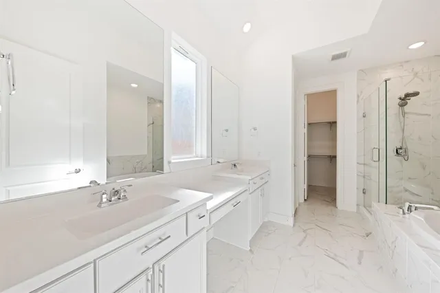 a spacious bathroom with a shower tub double and sink