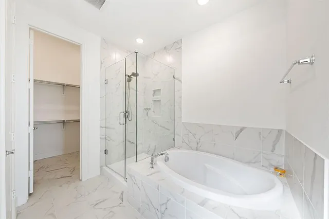 a bathroom with a bathtub and a shower