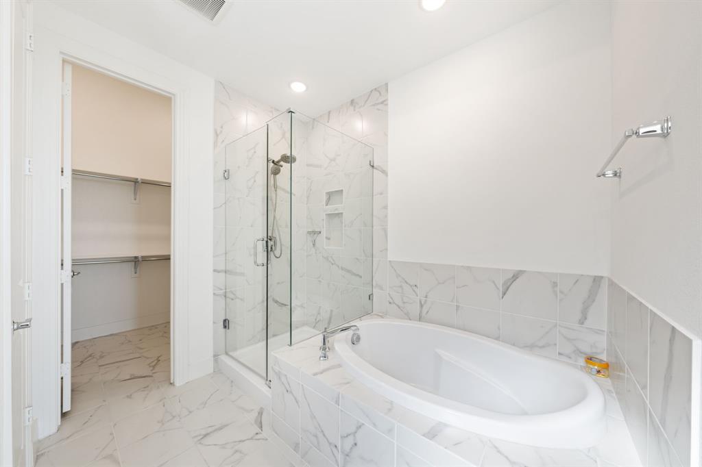 1723 Cypress Gap Trail Mansfield, TX 76063 - Photo 16 of 29 a bathroom with a bathtub and a shower