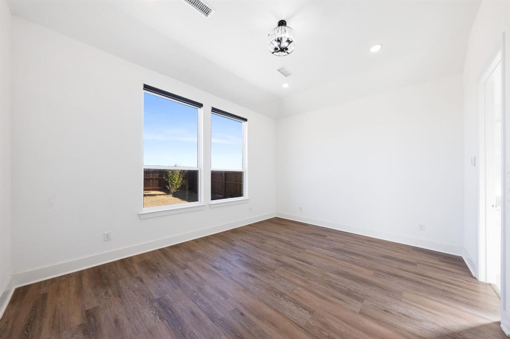 1723 Cypress Gap Trail Mansfield, TX 76063 - Photo 19 of 29 a view of an empty room with a window and wooden floor