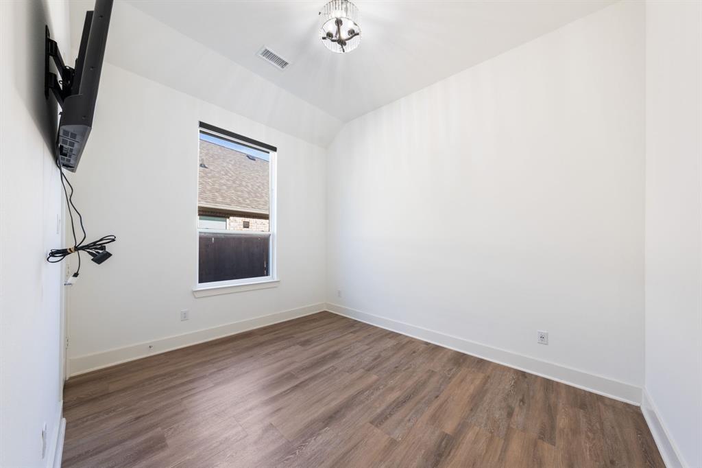 1723 Cypress Gap Trail Mansfield, TX 76063 - Photo 22 of 29 a view of a livingroom with wooden floor and a ceiling fan
