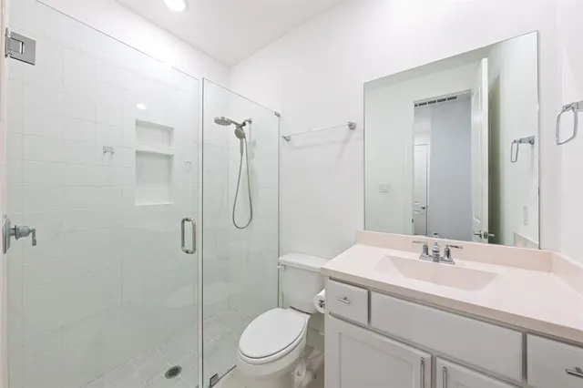 a bathroom with a sink toilet and shower