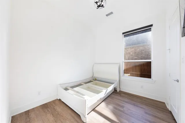 a living room with a bed and a table