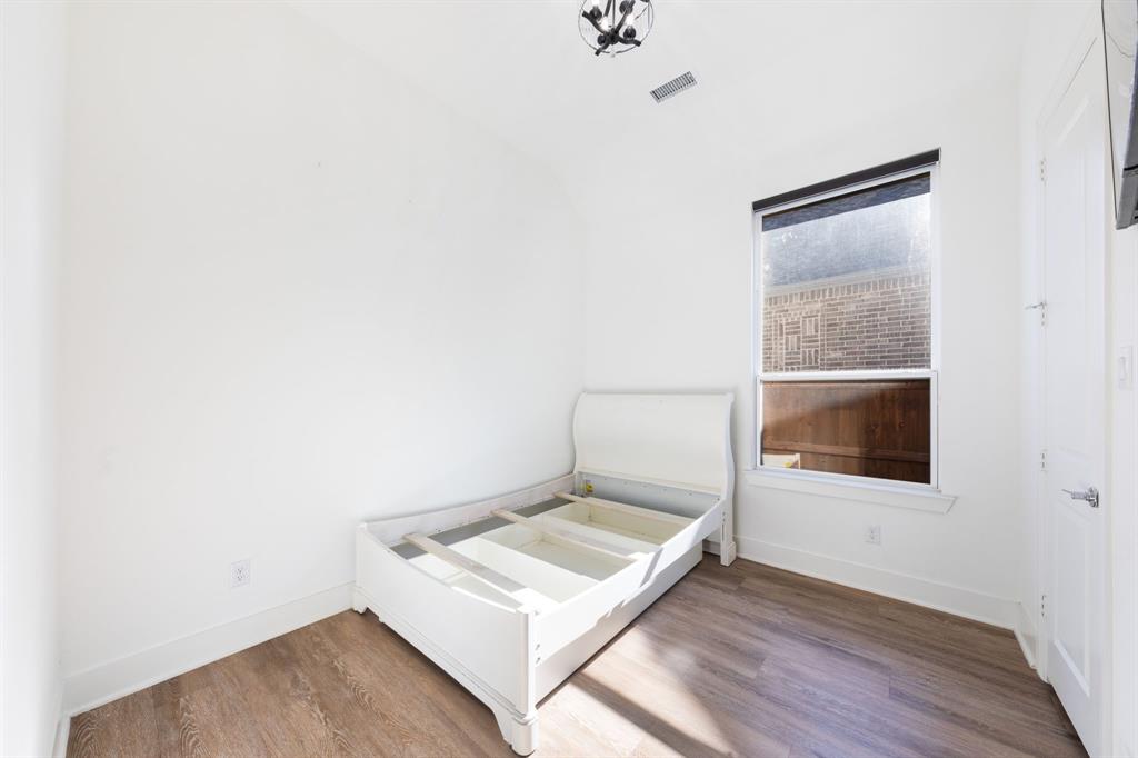 1723 Cypress Gap Trail Mansfield, TX 76063 - Photo 24 of 29 a living room with a bed and a table