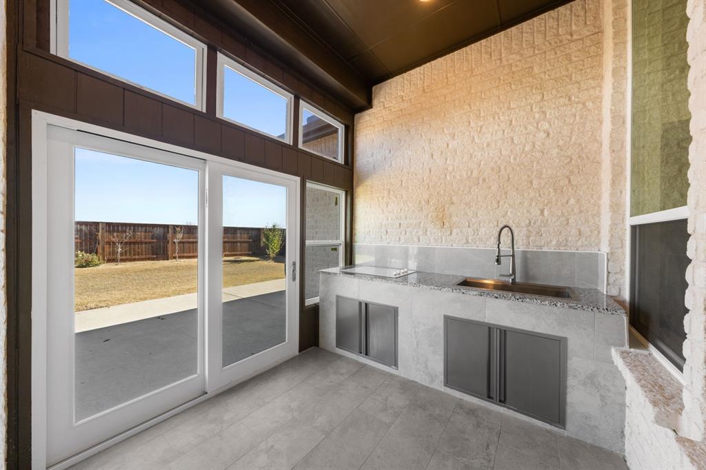 1723 Cypress Gap Trail Mansfield, TX 76063 - Photo 26 of 29 a kitchen with stainless steel appliances granite countertop a stove and a sink