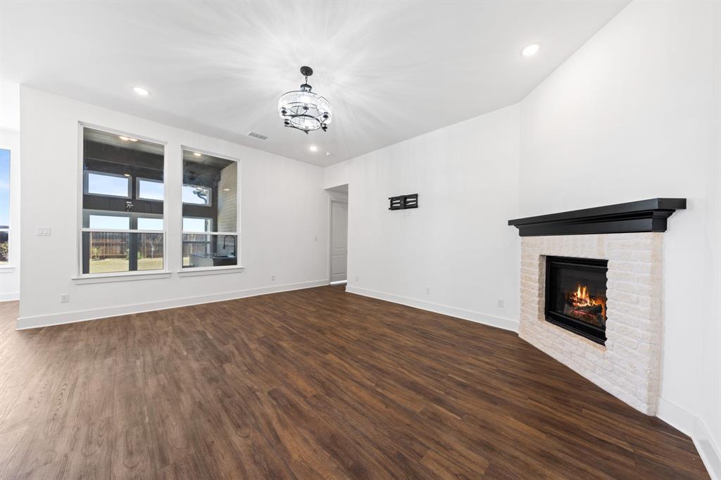 1723 Cypress Gap Trail Mansfield, TX 76063 - Photo 9 of 29 a view of an empty room with wooden floor fireplace and a window
