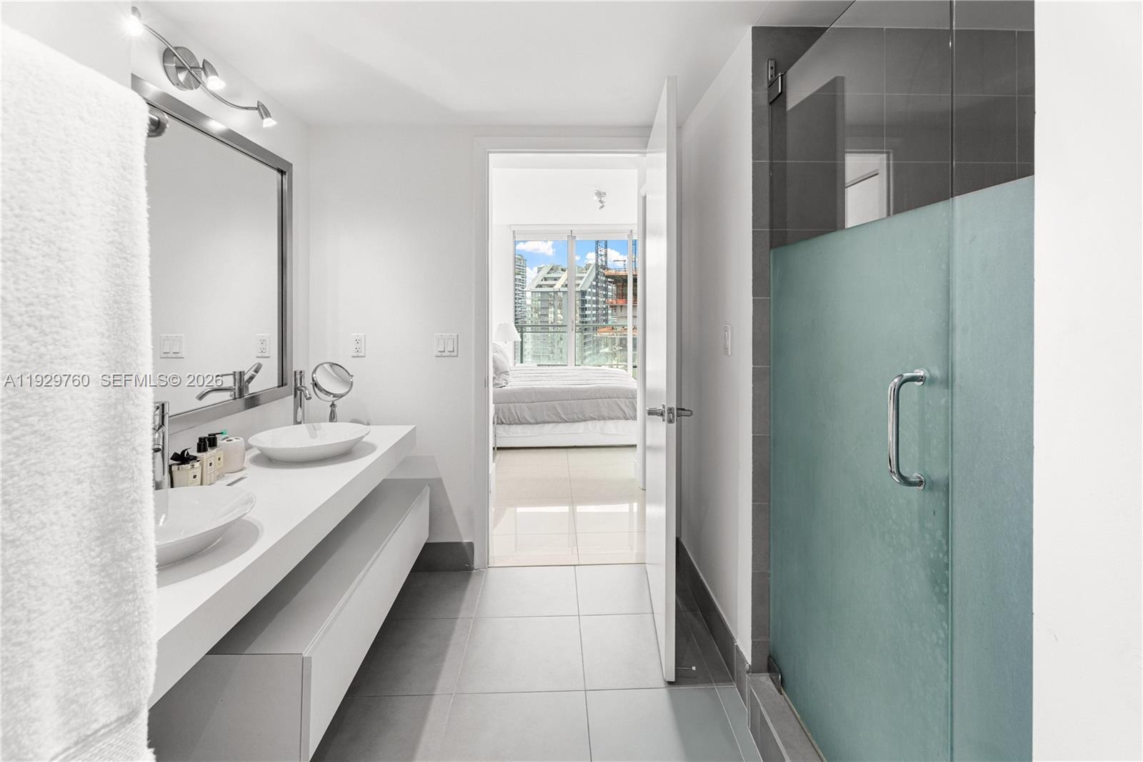 92 Southwest 3rd Street, Unit 4704 Miami, FL 33130 - Photo 13 of 34 a bathroom with a double vanity sink and mirror