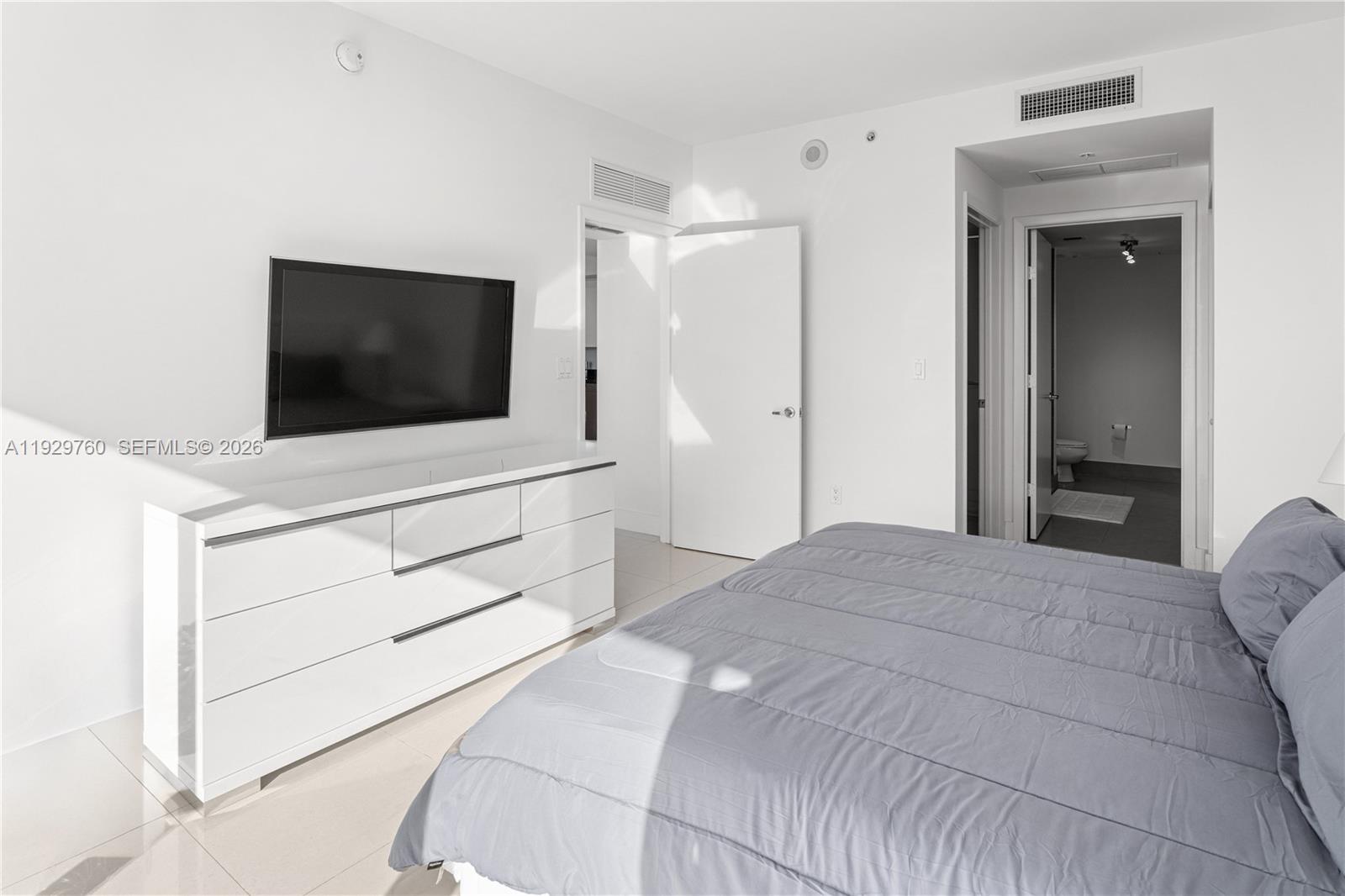 92 Southwest 3rd Street, Unit 4704 Miami, FL 33130 - Photo 17 of 34 a bedroom with a bed and a flat screen tv