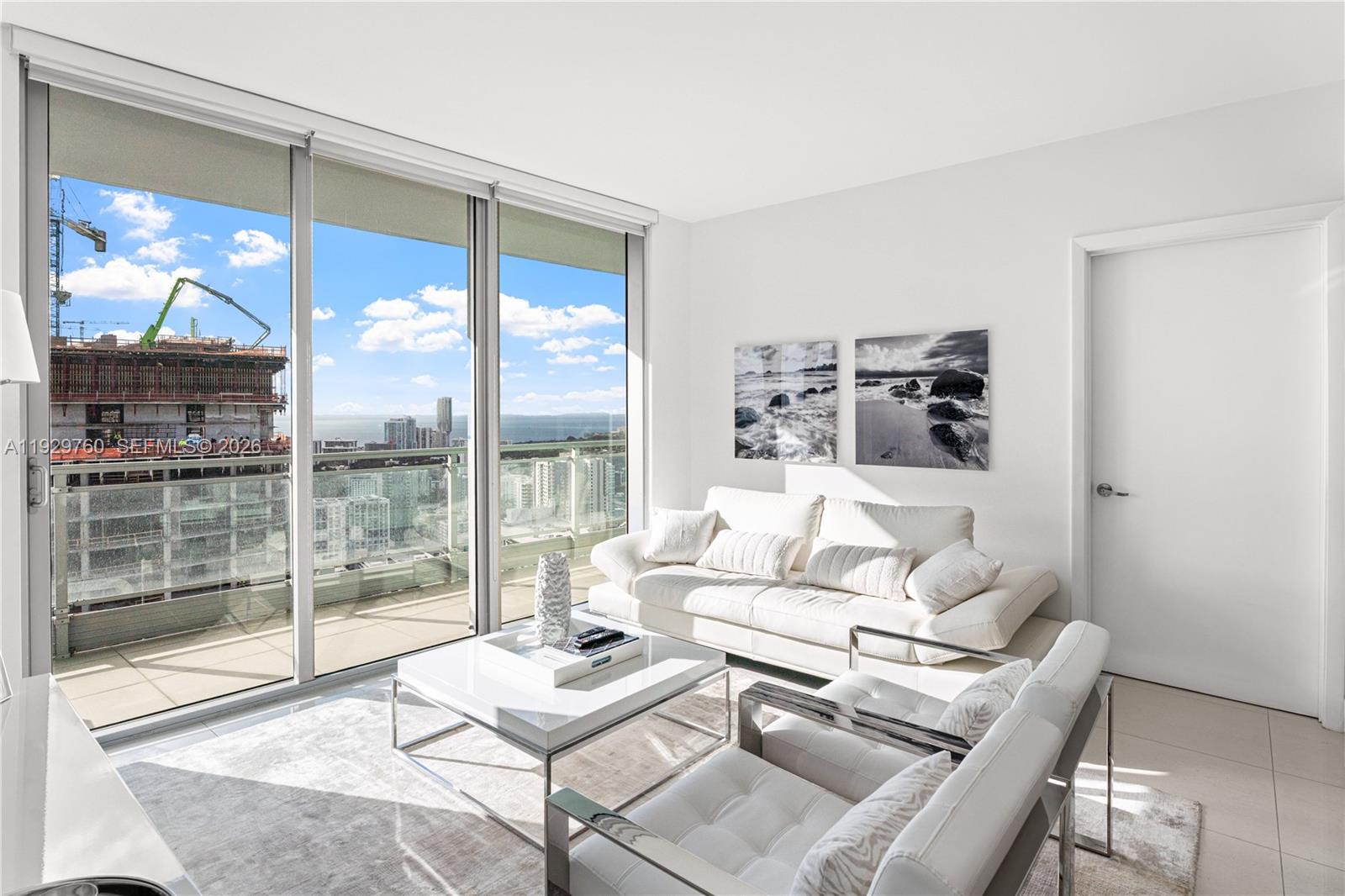 92 Southwest 3rd Street, Unit 4704 Miami, FL 33130 - Photo 18 of 34 a living room with furniture and a large window