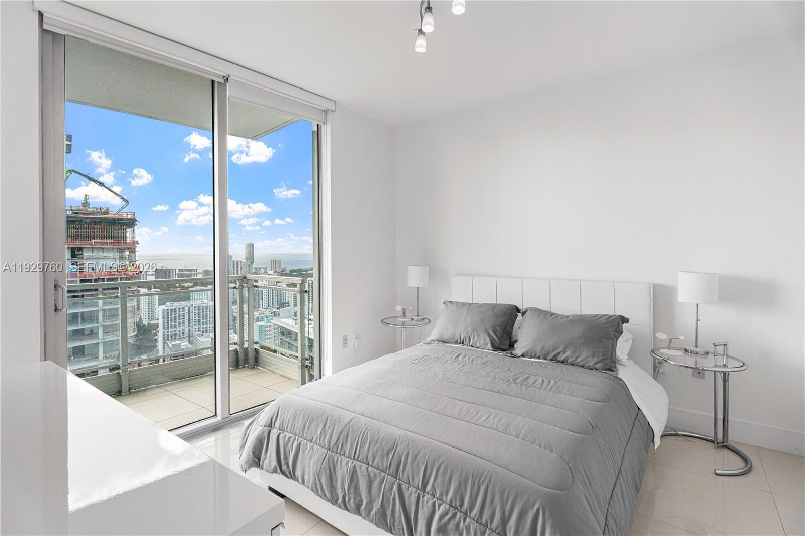 92 Southwest 3rd Street, Unit 4704 Miami, FL 33130 - Photo 19 of 34 a bedroom with a large window and a balcony