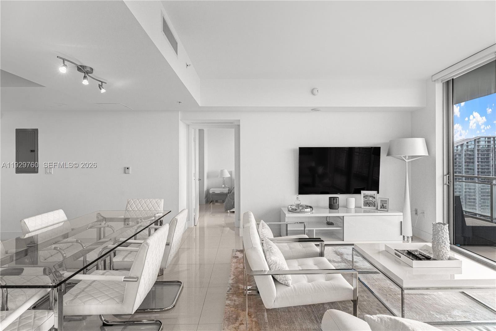 92 Southwest 3rd Street, Unit 4704 Miami, FL 33130 - Photo 22 of 34 a living room with furniture and a flat screen tv