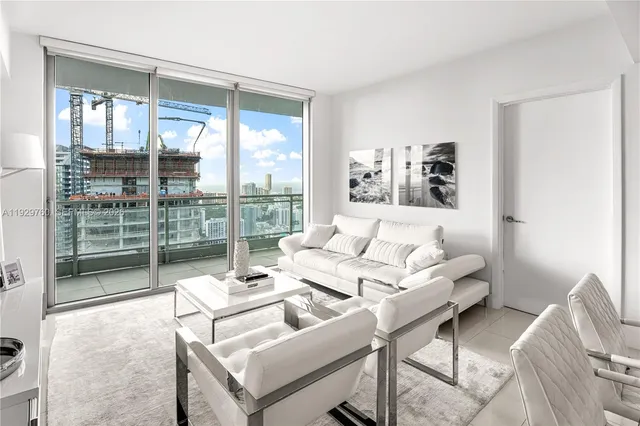 a kitchen with stainless steel appliances granite countertop a refrigerator a sink a stove a dining table and chairs