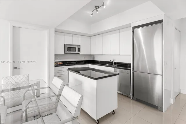 a dining room with furniture and large windows