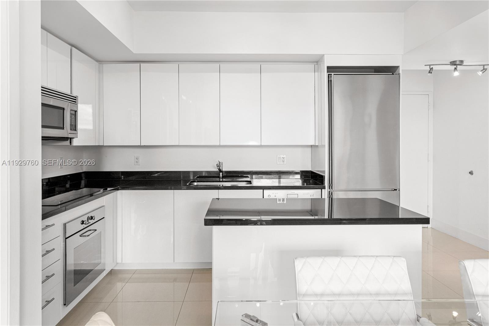 92 Southwest 3rd Street, Unit 4704 Miami, FL 33130 - Photo 10 of 34 a kitchen with cabinets and stainless steel appliances