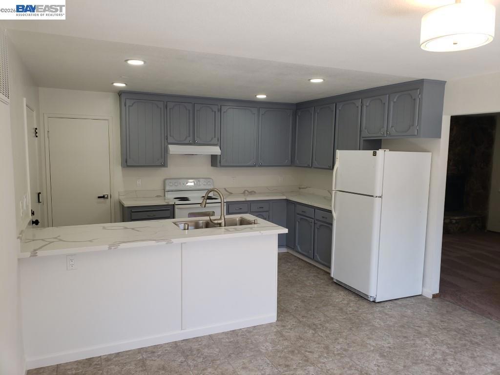 342 Washington Boulevard Fremont, CA 94539 - Photo 3 of 12 a kitchen with a refrigerator sink stove and cabinets