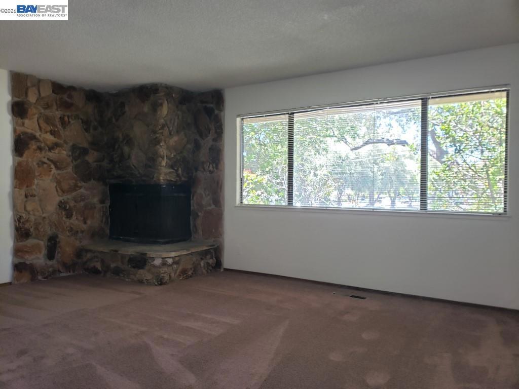 342 Washington Boulevard Fremont, CA 94539 - Photo 10 of 12 a living room with fireplace and a flat screen tv