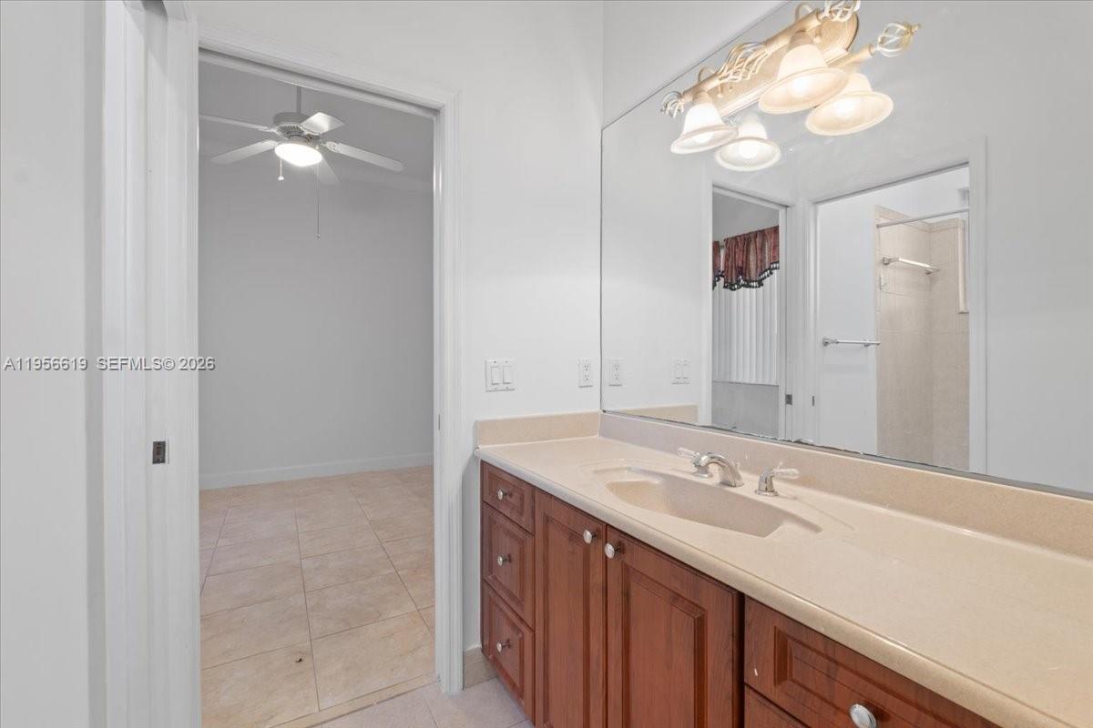 16640 Northwest 86th Court Miami Lakes, FL 33016 - Photo 14 of 23 a bathroom with a sink vanity and a mirror