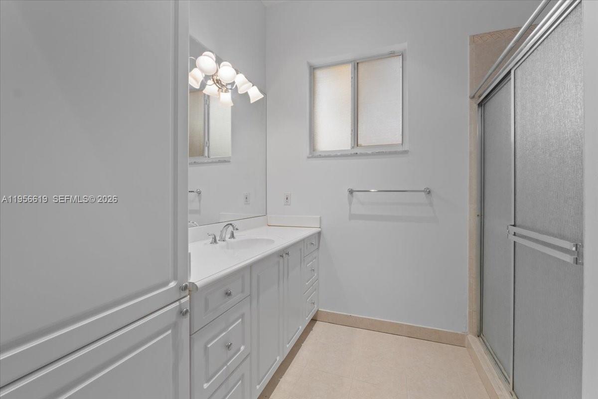 16640 Northwest 86th Court Miami Lakes, FL 33016 - Photo 17 of 23 a bathroom with a sink and a mirror