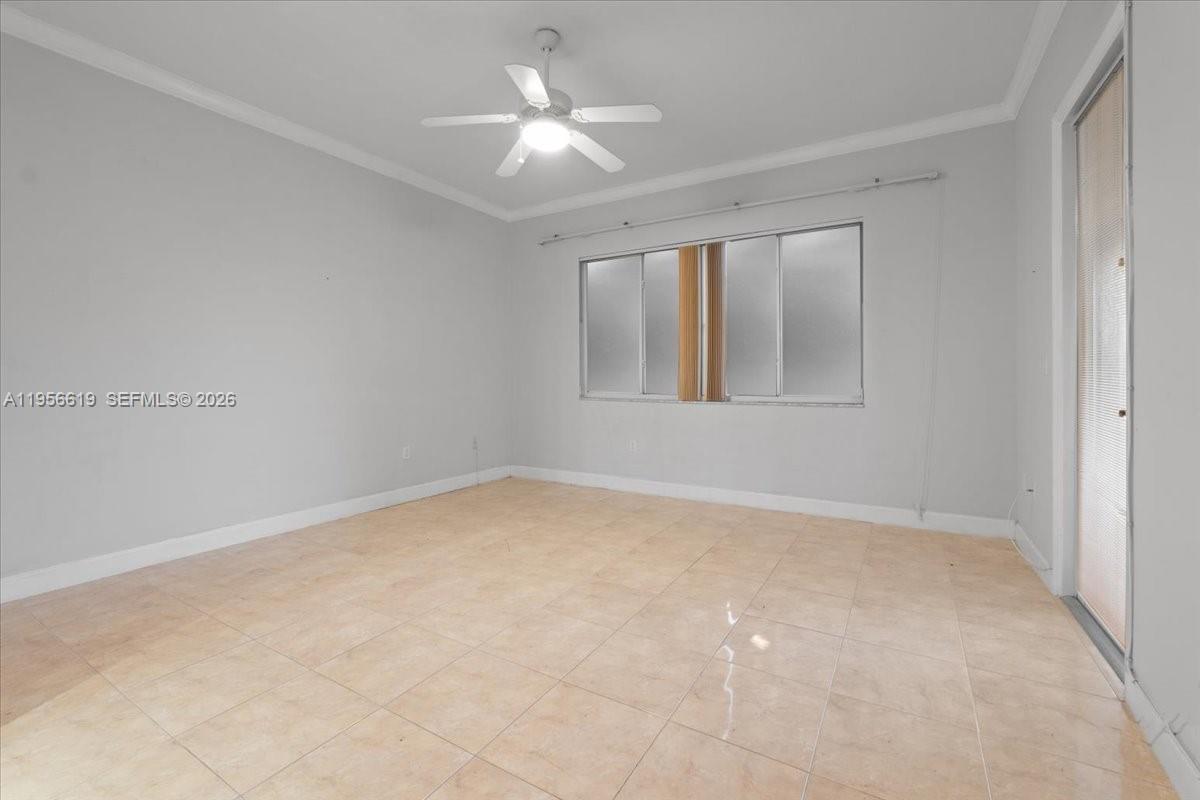 16640 Northwest 86th Court Miami Lakes, FL 33016 - Photo 18 of 23 an empty room with a ceiling fan and a window