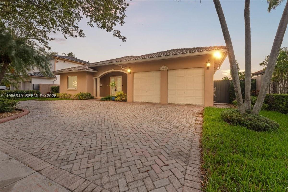 16640 Northwest 86th Court Miami Lakes, FL 33016 - Photo 23 of 23 a front view of a house with a yard and garage