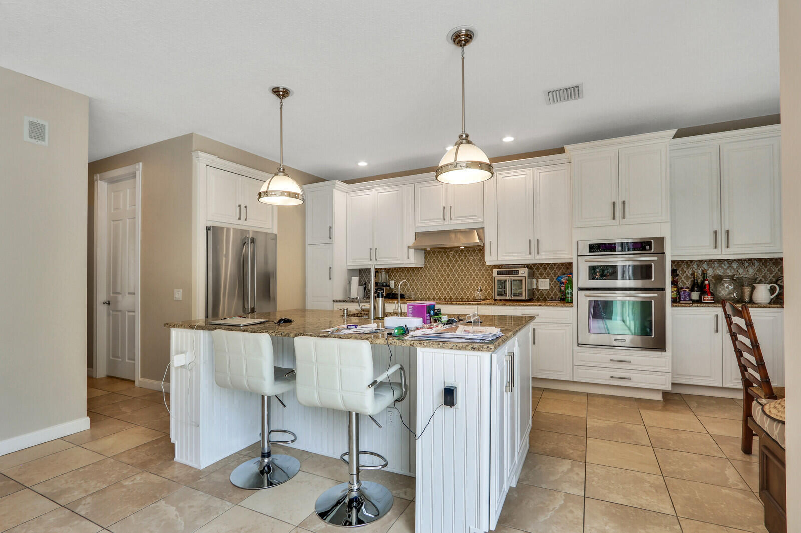 101 St Pierre Way Jupiter, FL 33458 - Photo 17 of 57 a kitchen that has a lot of cabinets in it and stainless steel appliances