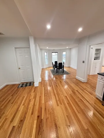 a view of an empty room and wooden floor
