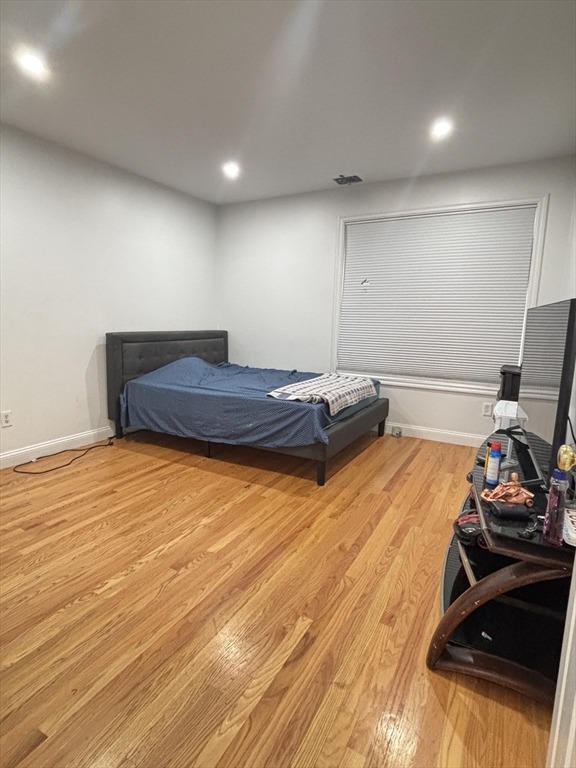 554 Main Street, Unit 2 Wakefield, MA 01880 - Photo 7 of 16 a room with a bed and wooden floor