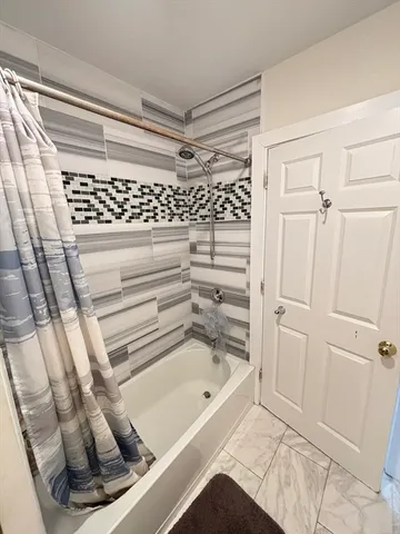 a bathroom with a bathtub and a shower