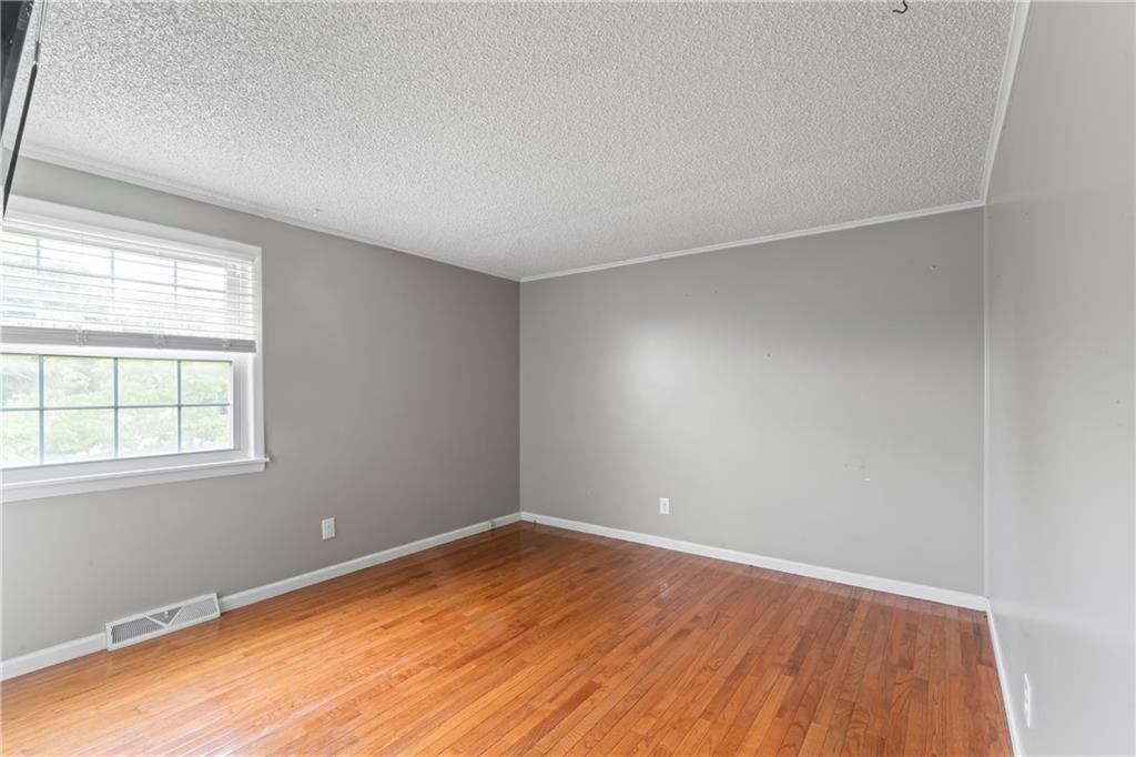 1032 Grove Street Monaca, PA 15061 - Photo 11 of 25 an empty room with wooden floor and windows