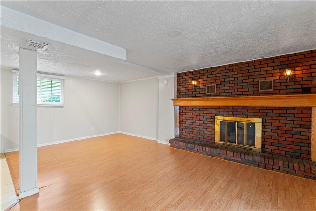 1032 Grove Street Monaca, PA 15061 - Photo 14 of 25 a view of an empty room with wooden floor and windows