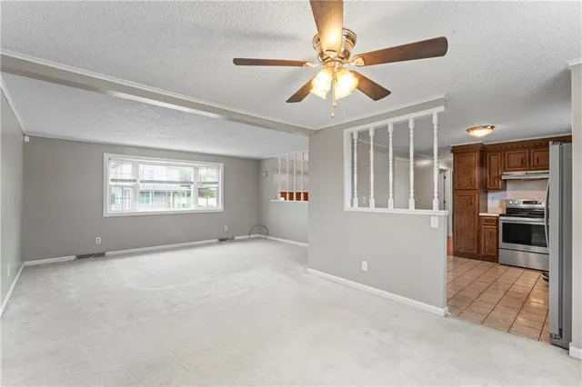 a kitchen with stainless steel appliances a refrigerator sink and microwave