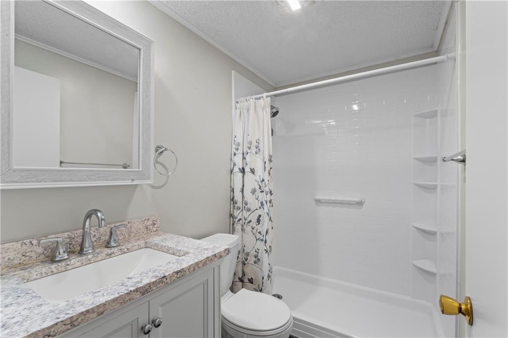 1032 Grove Street Monaca, PA 15061 - Photo 8 of 25 a bathroom with a granite countertop sink toilet mirror and shower
