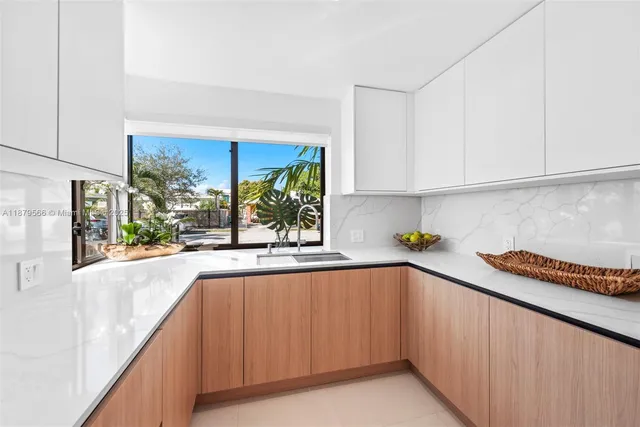 a kitchen with a sink and cabinets