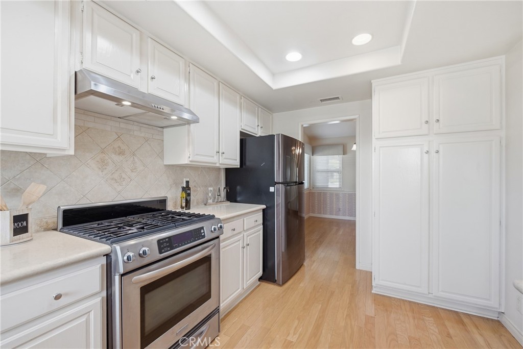 13693 Bear Valley Road Moorpark, CA 93021 - Photo 18 of 44 a kitchen with a stove a refrigerator and a sink