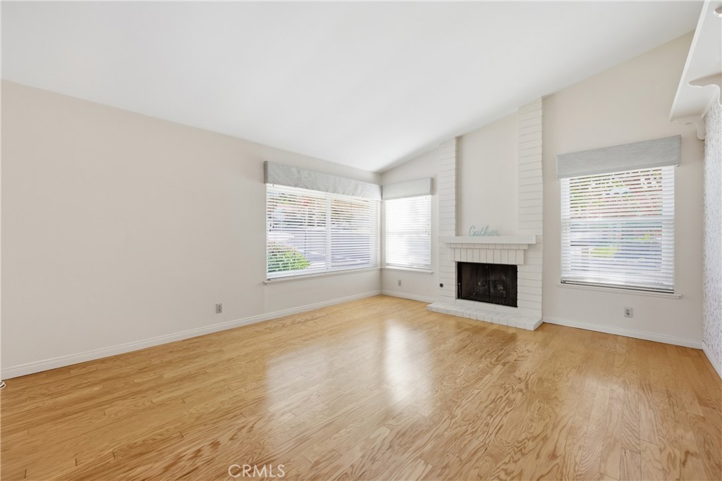 13693 Bear Valley Road Moorpark, CA 93021 - Photo 22 of 44 a view of empty room with wooden floor and fireplace