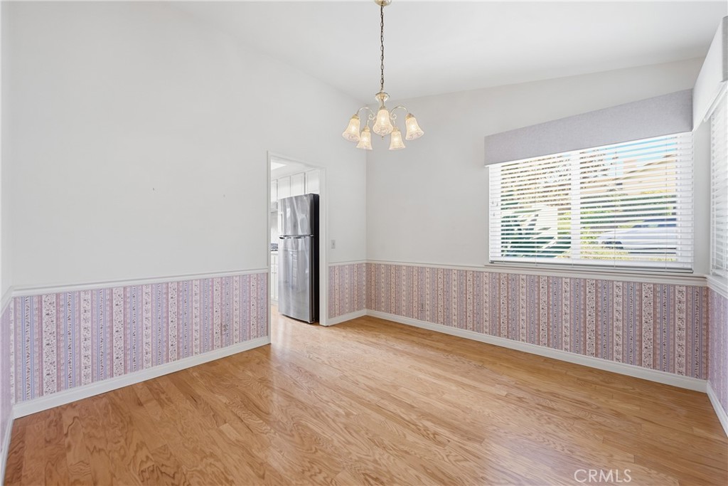 13693 Bear Valley Road Moorpark, CA 93021 - Photo 26 of 44 a view of a livingroom with a chandelier fan and wooden floor