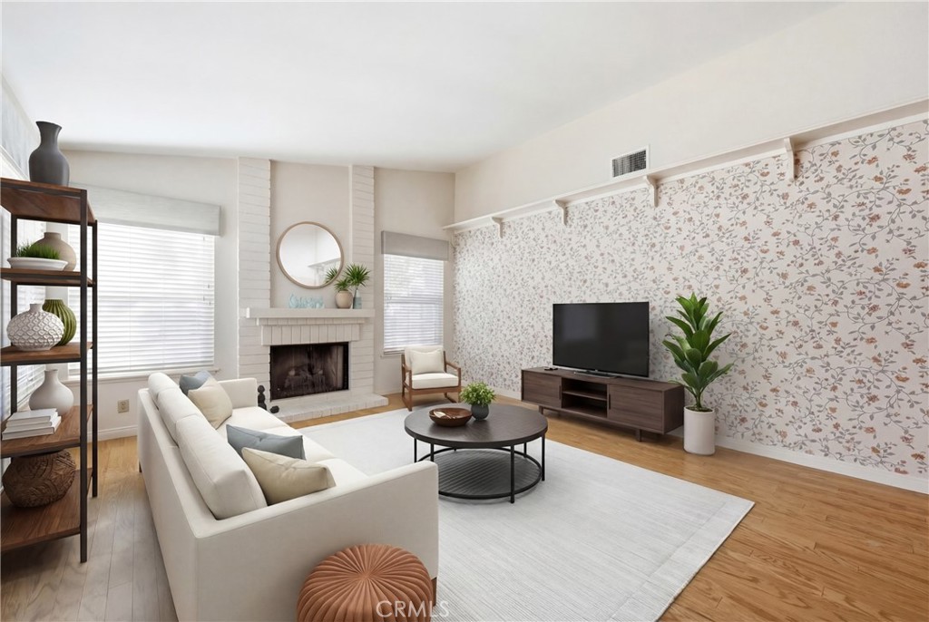13693 Bear Valley Road Moorpark, CA 93021 - Photo 6 of 44 a living room with furniture a fireplace and a flat screen tv