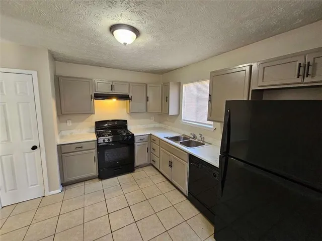 a kitchen with a sink and a refrigerator