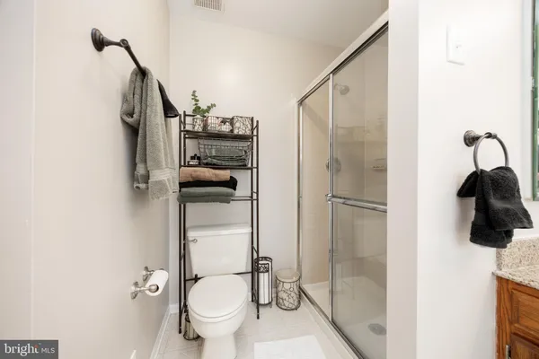 a bathroom with a toilet and a shower